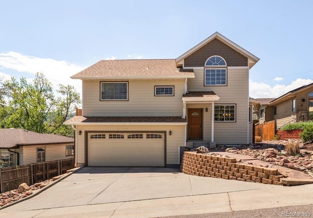 420 Sunshine Pkwy, Golden, CO 80403 - view of front of house with fence, driveway, an attached garage, and roof with shingles