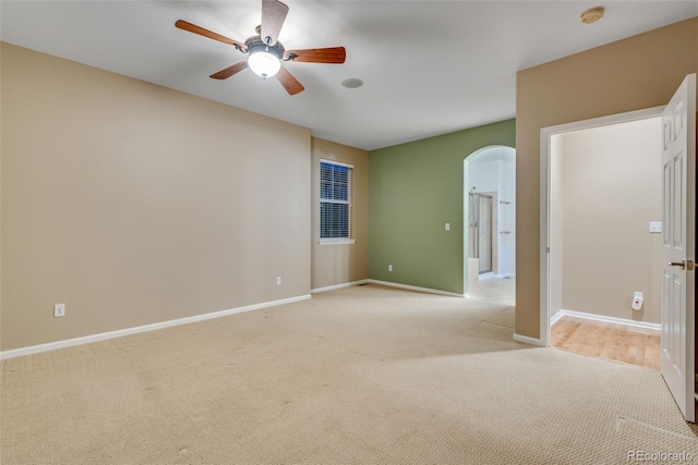 spare room with light carpet and ceiling fan