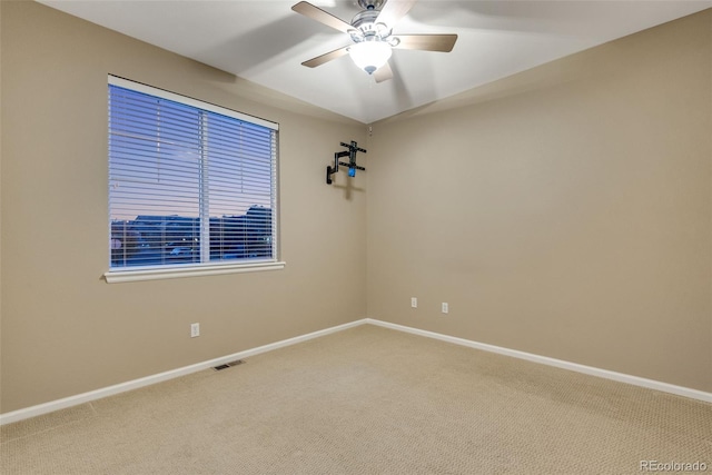 carpeted empty room featuring ceiling fan