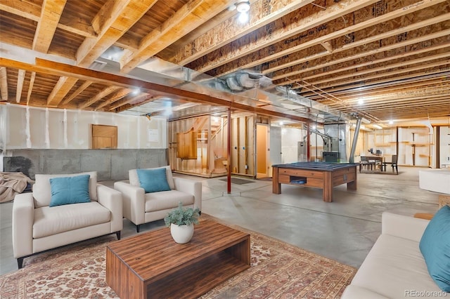 playroom featuring concrete floors and water heater