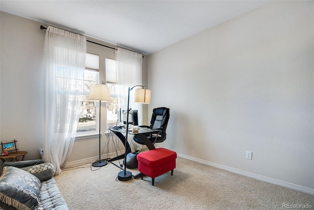 living area featuring carpet floors and baseboards