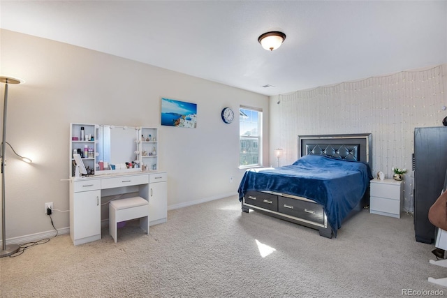 bedroom with light colored carpet and baseboards