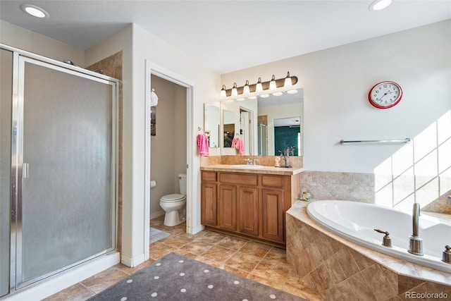 bathroom with a garden tub, toilet, a shower stall, vanity, and tile patterned flooring