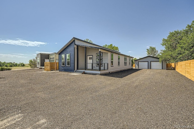 view of front of property featuring an outdoor structure and a garage