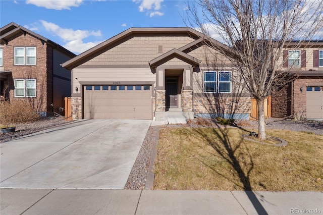 25127 E Maple Ave, Aurora, CO 80018 - craftsman inspired home with a garage, driveway, a front yard, and stone siding