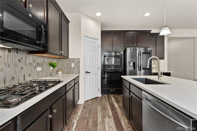 25127 E Maple Ave, Aurora, CO 80018 - kitchen featuring black appliances, a sink, dark wood-type flooring, dark brown cabinetry, and decorative backsplash