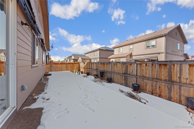 25127 E Maple Ave, Aurora, CO 80018 - yard covered in snow featuring a fenced backyard and a residential view