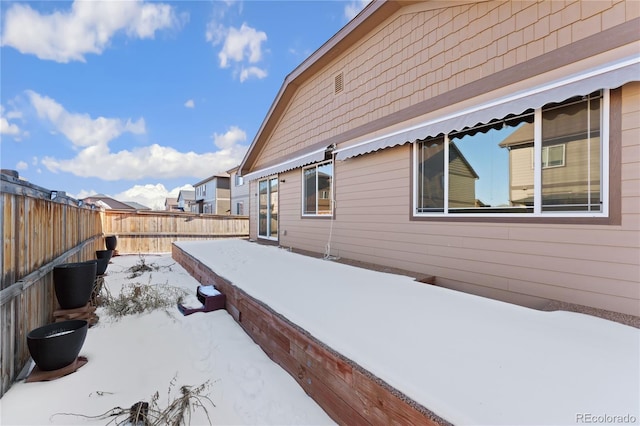 25127 E Maple Ave, Aurora, CO 80018 - view of snow covered exterior with a fenced backyard