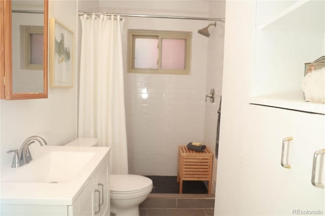 bathroom featuring vanity, curtained shower, tile patterned floors, and toilet