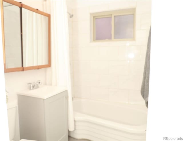 full bathroom with vanity, toilet, and tiled shower / bath combo