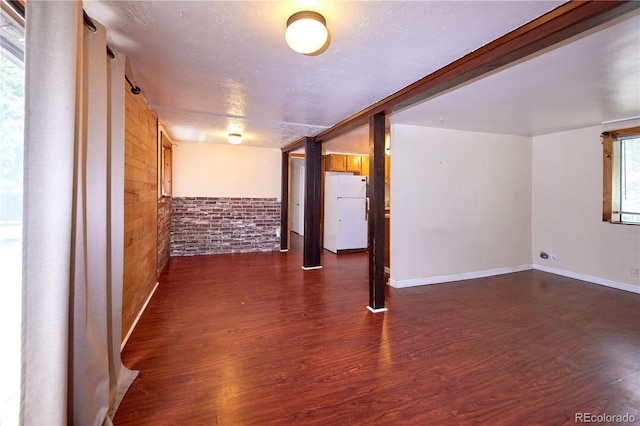1703 W Weaver Ave, Littleton, CO 80120 - unfurnished room featuring dark wood-type flooring, a textured ceiling, and baseboards