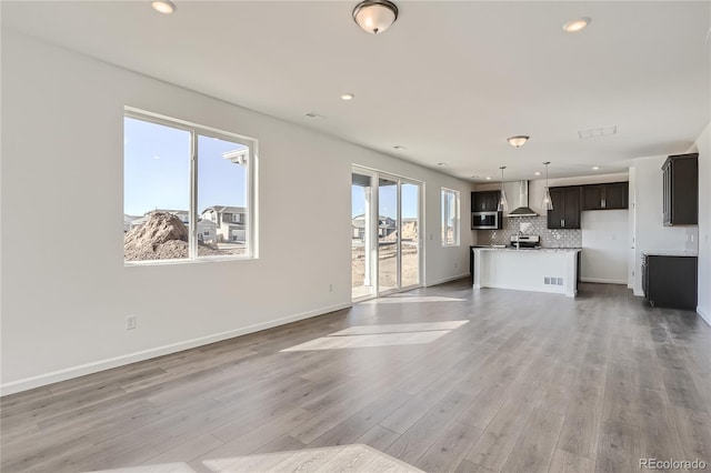 unfurnished living room featuring light wood-type flooring