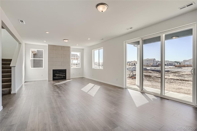 unfurnished living room with wood-type flooring and a fireplace