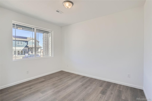 empty room with wood-type flooring