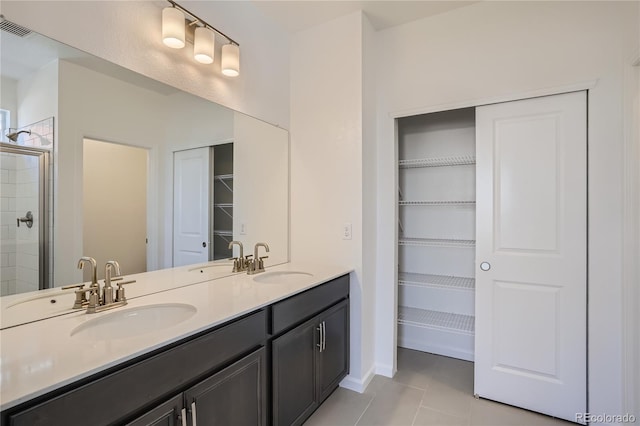 bathroom featuring vanity, tile patterned floors, and walk in shower