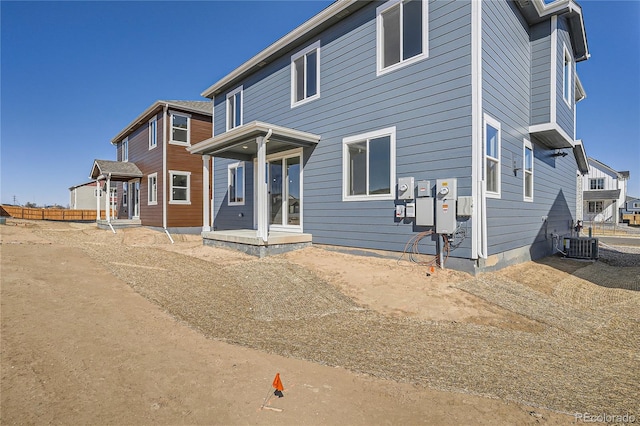 rear view of house with central AC unit