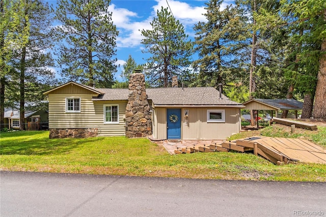 26351 Sheldon St, Kittredge, CO 80457 - view of front of property featuring a chimney, a front lawn, and roof with shingles