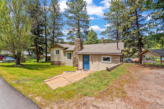 26351 Sheldon St, Kittredge, CO 80457 - view of front facade with a chimney, roof with shingles, a front lawn, and a carport