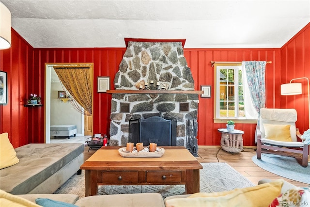 26351 Sheldon St, Kittredge, CO 80457 - living area with wood finished floors, a fireplace, and wood walls