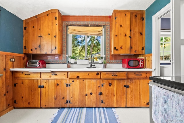 26351 Sheldon St, Kittredge, CO 80457 - kitchen featuring brown cabinets, light countertops, and plenty of natural light