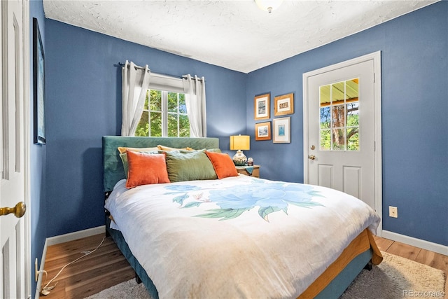 26351 Sheldon St, Kittredge, CO 80457 - bedroom with baseboards, wood finished floors, and a textured ceiling
