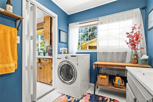 26351 Sheldon St, Kittredge, CO 80457 - laundry area featuring washer / dryer, plenty of natural light, and baseboards