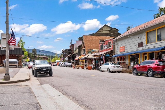 26351 Sheldon St, Kittredge, CO 80457 - view of asphalt street with street lighting, a mountain view, and sidewalks