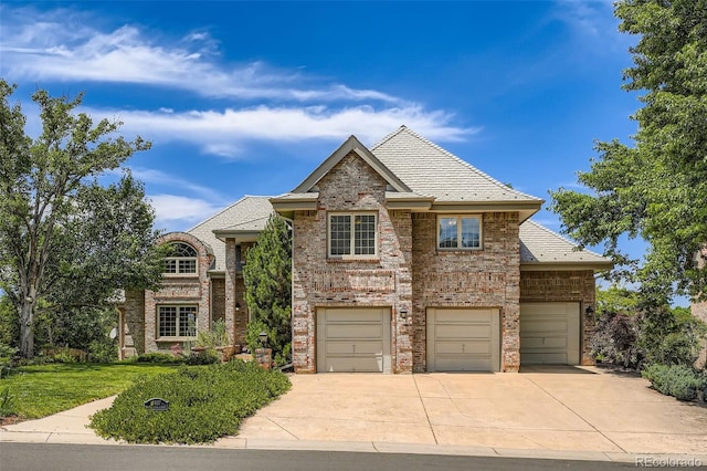 13837 W 59th Pl, Arvada, CO 80004 - view of front of house featuring driveway, brick siding, a high end roof, and an attached garage