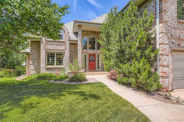 13837 W 59th Pl, Arvada, CO 80004 - entrance to property featuring a yard, brick siding, and a garage