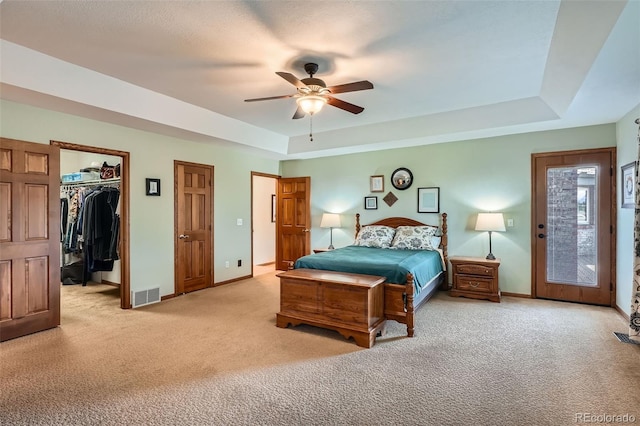 13837 W 59th Pl, Arvada, CO 80004 - bedroom with light carpet, a raised ceiling, a ceiling fan, and a spacious closet