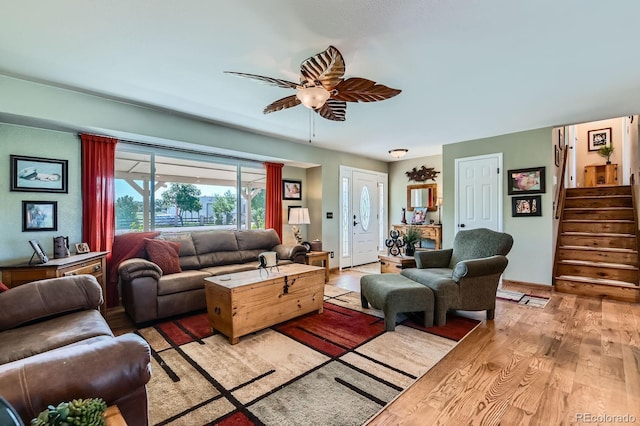 15373 Uravan St, Brighton, CO 80601 - living room with light wood-style flooring, stairway, and a ceiling fan