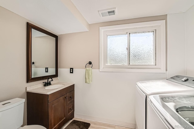 15373 Uravan St, Brighton, CO 80601 - bathroom featuring washing machine and dryer and vanity