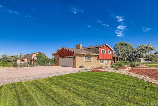 15373 Uravan St, Brighton, CO 80601 - split level home with a chimney, brick siding, driveway, a gambrel roof, and an attached garage