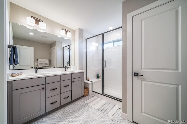 bathroom featuring a sink, a shower stall, and double vanity
