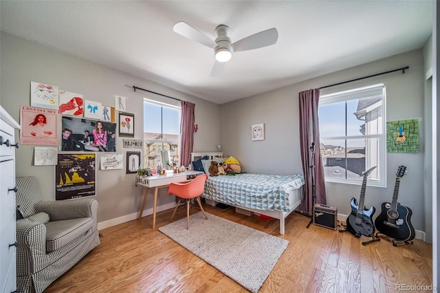 bedroom featuring baseboards, a ceiling fan, and wood finished floors