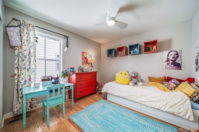 bedroom with a ceiling fan, visible vents, and light wood-type flooring