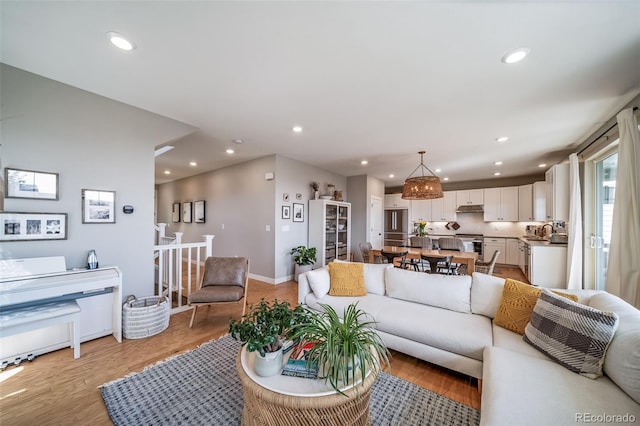 living area featuring light wood-style floors and recessed lighting