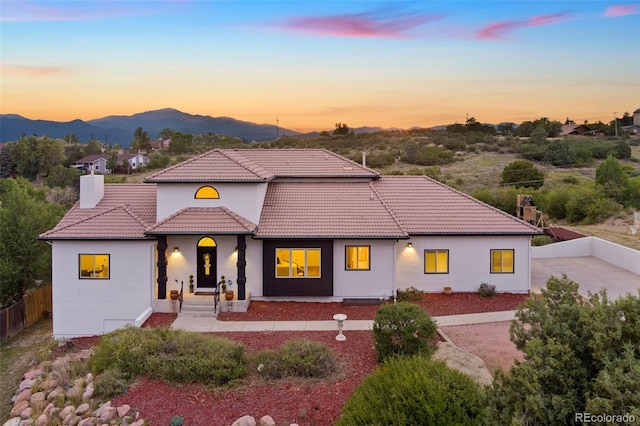 view of front of property featuring a patio and a mountain view