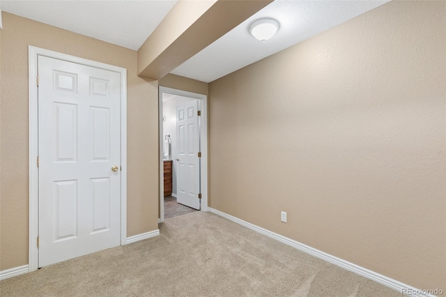 unfurnished bedroom featuring light carpet