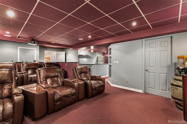 cinema room featuring a paneled ceiling and carpet floors