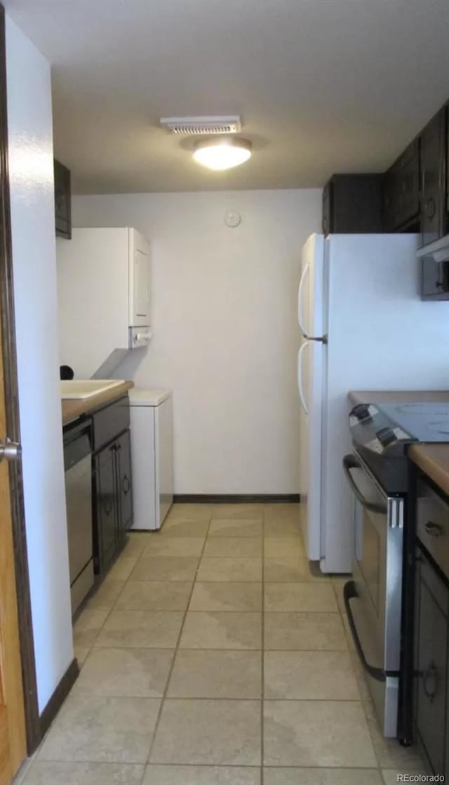 kitchen with dishwasher, light tile flooring, and stainless steel range with electric cooktop