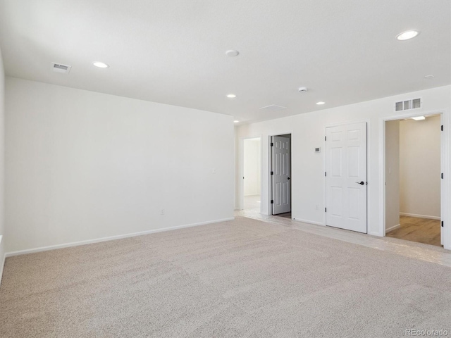 empty room featuring light carpet