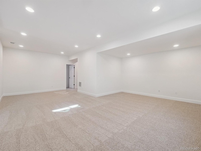 unfurnished room featuring light carpet