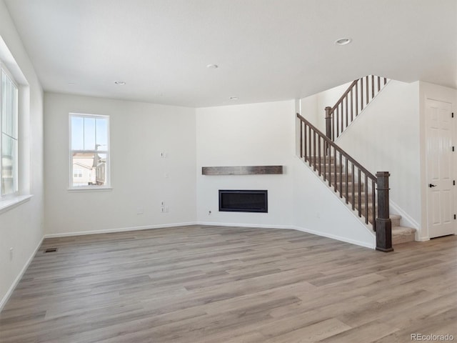 unfurnished living room featuring light hardwood / wood-style floors