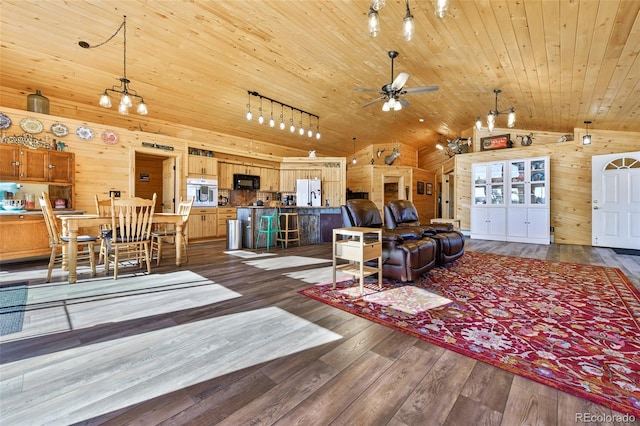 living area with wood walls, wood ceiling, lofted ceiling, dark wood-style floors, and a ceiling fan