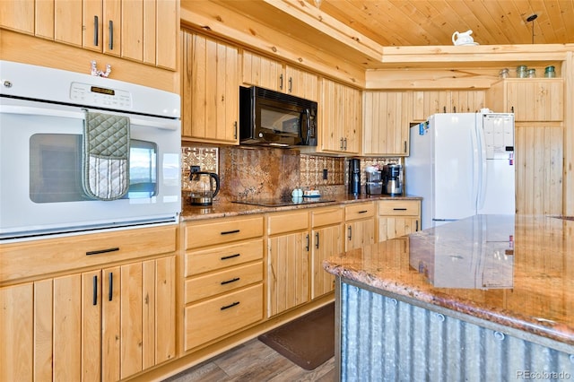 kitchen featuring light stone counters, light brown cabinetry, decorative backsplash, black appliances, and wood ceiling