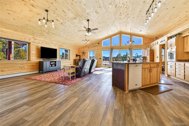 kitchen with white appliances, wood finished floors, wood ceiling, wood walls, and open floor plan