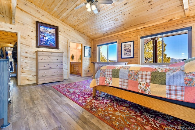 bedroom featuring connected bathroom, wood walls, wood ceiling, lofted ceiling, and wood-type flooring