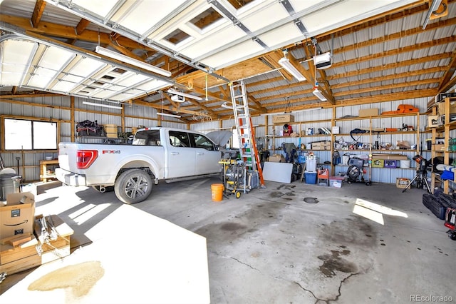 garage featuring metal wall and a garage door opener