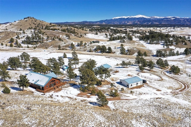 snowy aerial view featuring a mountain view